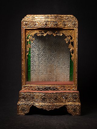 Antique wooden Burmese temple shrine, front view with gilt carving and glass panels