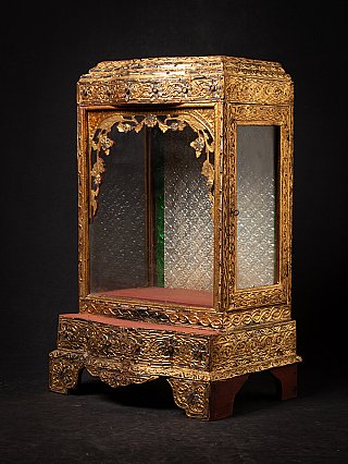 Burmese wooden temple shrine, three-quarter view showing corner glazing and gilt decoration