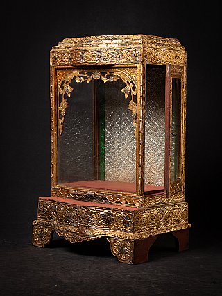 Antique Burmese shrine, angled front view with side glass panel and red interior shelf
