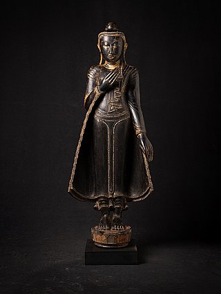 Burmese wooden Buddha statue, full front view, standing with one hand raised at the chest