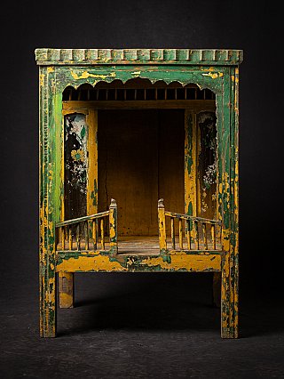 Antique wooden Indian temple shrine front view, open niche with small railings