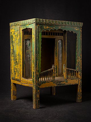 Antique wooden Indian temple shrine in three-quarter view with open front and railings