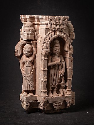 Wooden Jain temple fragment from India with arched niche and attendant figure, angled view