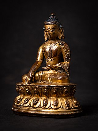 Gilt and lacquered Tibetan Shakyamuni Buddha statue seated, three-quarter view