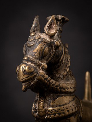 Close-up of the bronze horse head with engraved ornament, angled front view