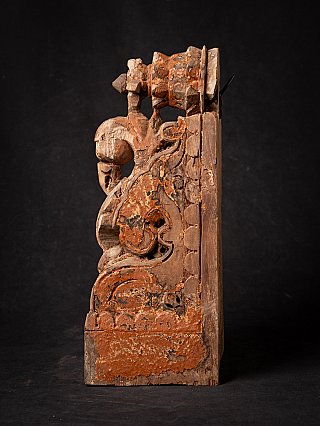 Indian wooden temple fragment showing scrolling side carving, side profile view