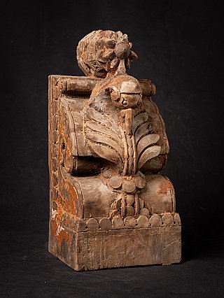 Antique Indian wooden temple fragment with floral and leaf relief, three-quarter view