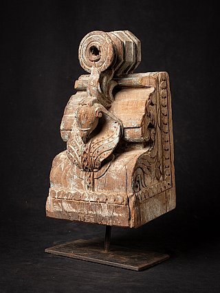 Antique Indian wooden temple fragment on metal stand, three-quarter view with animal head carving