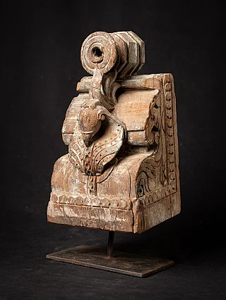 Antique Indian wooden temple fragment on metal stand, three-quarter view with animal head carving