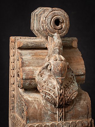 Detail of the Indian wooden temple fragment showing animal head and circular opening