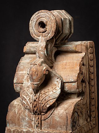 Indian wooden temple fragment, angled view with animal head and moulded edge