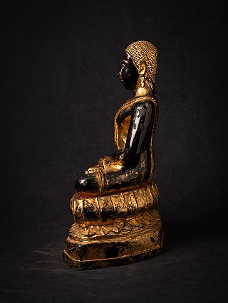 Thai bronze monk statue on lotus base, left side profile