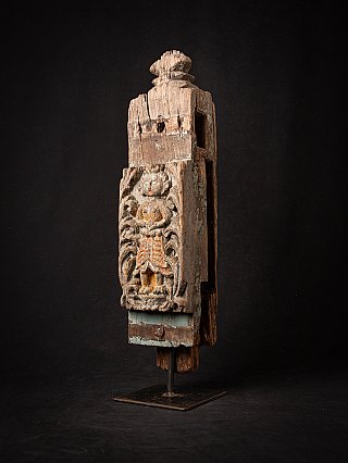 Indian wooden temple panel with carved relief figure, three-quarter view