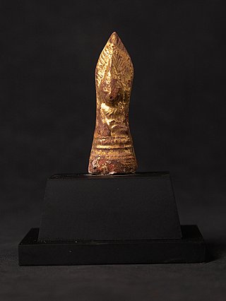 Burmese wooden Buddha statue amulet with gilded surface, full front view on black base