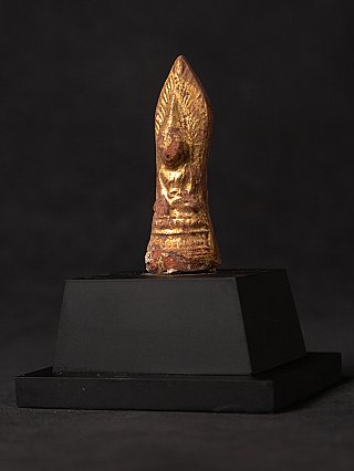 Buddha statue amulet from Myanmar in wood with gilding, three-quarter view on base