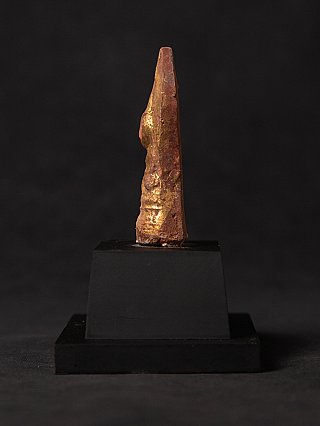 Wooden Buddha statue amulet from Myanmar with traces of gilding, side profile on base