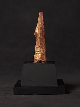 Burmese wooden Buddha statue amulet with gilded areas, side view with dark patina