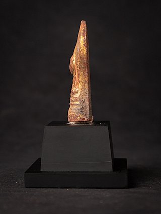 Houten Boeddha-amulet uit Myanmar, zijaanzicht met slanke vorm op zwarte sokkel