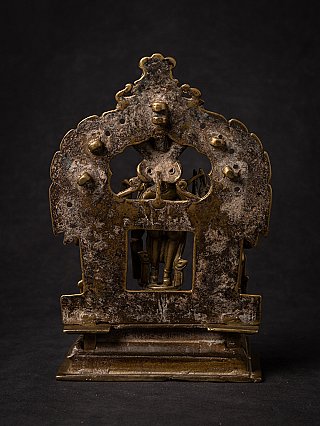 Rear view of the bronze Virabhadra plaque showing aged surface and central opening