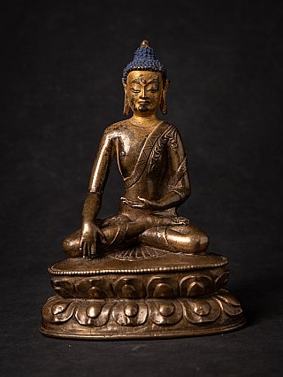 Tibetan bronze Buddha statue seated in bhumisparsha mudra on lotus base, full-front view