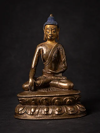 Tibetan bronze Buddha statue seated in bhumisparsha mudra on lotus base, full-front view