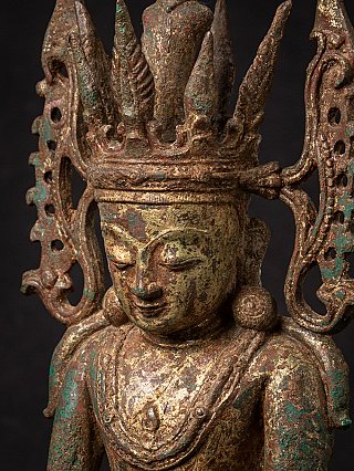 Angled face detail of the Burmese bronze Buddha statue, showing crown spikes