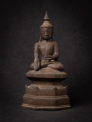 Burmese bronze Buddha statue seated in bhumisparsha mudra, full front view on tiered base