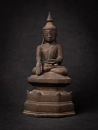 Burmese bronze Buddha statue seated in bhumisparsha mudra, full front view on tiered base