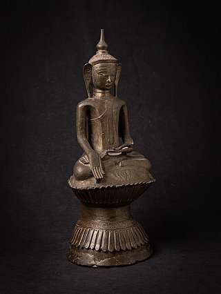 Burmese Buddha statue in bronze, three-quarter view highlighting bhumisparsha mudra