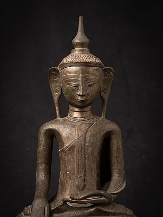 Front face detail of the Burmese bronze Buddha with elongated ears and headpiece