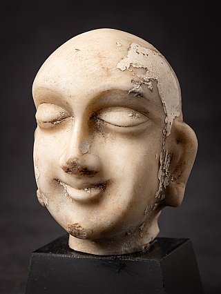 Detail of the Jain marble head (JA-163) showing flaking surface on the temple