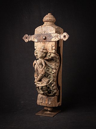 Indian wooden temple fragment in three-quarter view with relief figure and iron strap