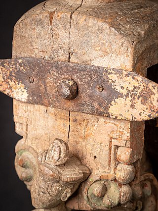 Close-up of the iron strap with bolt on the antique wooden temple fragment