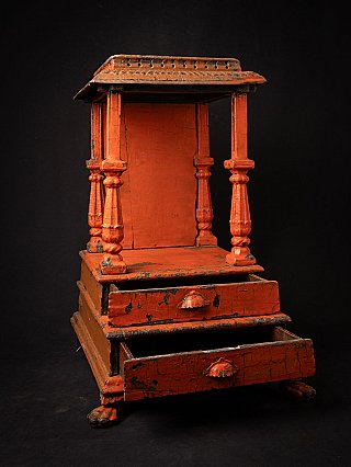 Wooden Indian temple shrine with lower drawer pulled out, three-quarter view