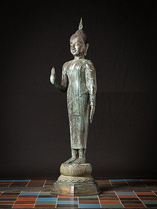Old standing bronze Thai Buddha statue