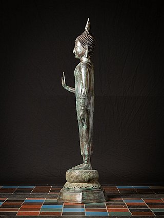 Old standing bronze Thai Buddha statue
