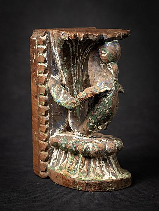 Antique Indian wooden temple fragment with painted bird bracket, three-quarter view