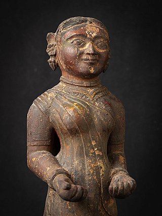 Head and upper torso detail of the wooden Indian lady statue with worn polychrome paint