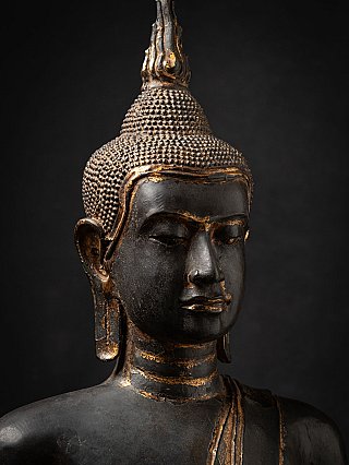 Face detail of the Thai bronze Buddha with ushnisha, three-quarter view