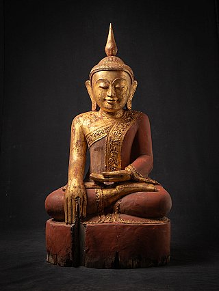 Burmese wooden Buddha statue seated in bhumisparsha mudra, full front view with gilded face