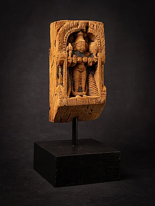 Wooden panel of the standing goddess Parvati from India on display stand, three-quarter left view