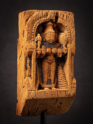 Close-up of the Parvati relief on the wooden panel, showing arched niche and frame