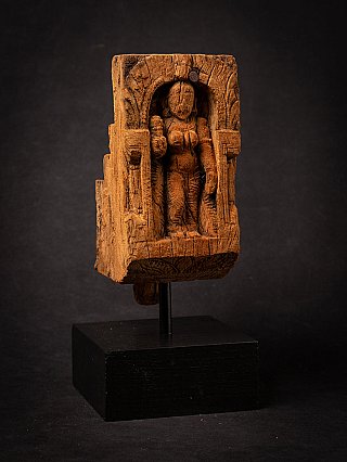 Wooden panel of the goddess Parvati standing in a niche, three-quarter view on black stand