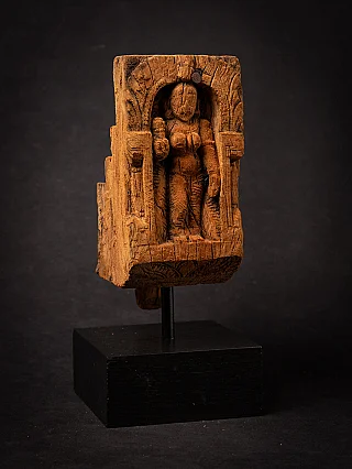 Wooden panel of the goddess Parvati standing in a niche, three-quarter view on black stand