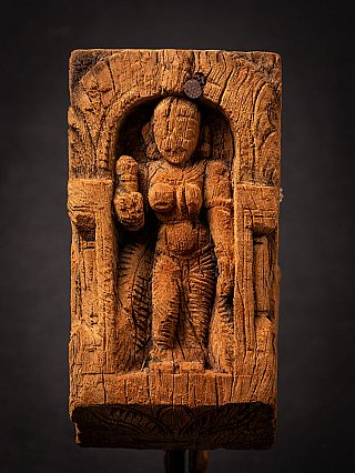 Parvati wooden relief with standing figure centered in the niche, front close-up