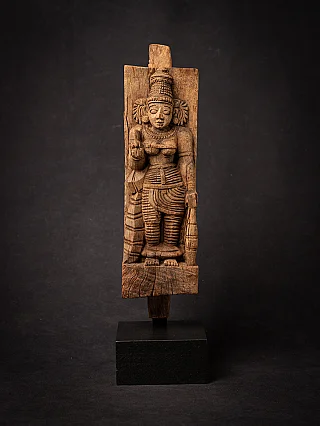 Wooden panel of the goddess Devi from India, standing relief shown from the front on black base