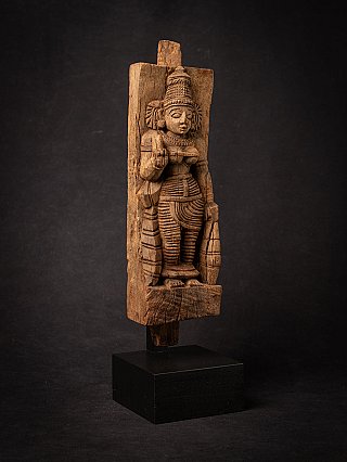 Wooden Devi panel from India, three-quarter view with the raised hand and carving details visible