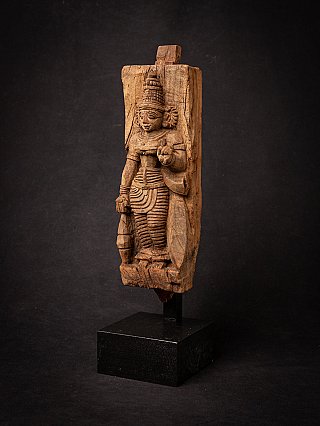 Devi wooden panel statue from India, three-quarter view showing the relief depth