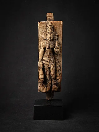 Wooden relief panel of the goddess Devi from India, full front view on black base