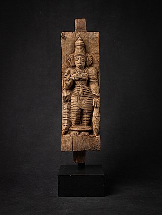 Wooden panel of the goddess Devi from India, full front view on a black display stand